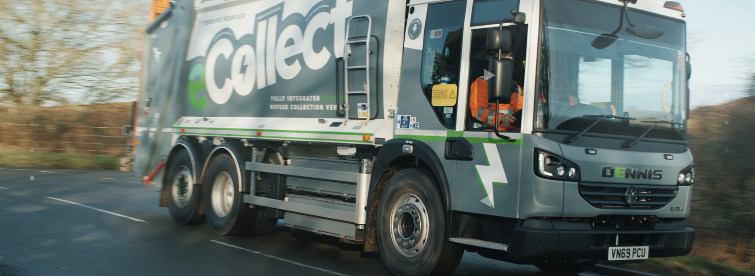 Electric bin lorry driving on a road